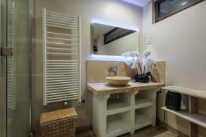 a bathroom with a sink and a mirror at Maison Flammarion - Welkeys in Avignon
