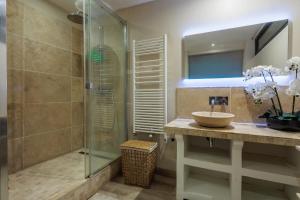 a bathroom with a sink and a glass shower at Maison Flammarion - Welkeys in Avignon +11 photos