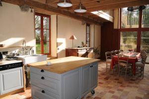 a kitchen and dining room with a table and chairs at Le refuge de théoline in Lathus St Remy