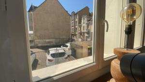 a cat is sitting in a cage in a window at test in Saint-Avertin