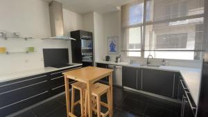 a kitchen with a wooden stool and a table in it at test in Saint-Avertin