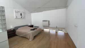 a bedroom with a bed in a white room at test in Saint-Avertin