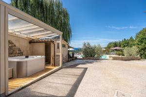 a bath tub sitting outside of a building with a patio at Villa Morotti by Mmega in Montone