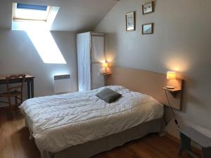 a bedroom with a bed and two lamps and a window at Gîte lamarlière in Savigny-sous-Faye