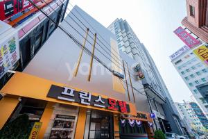 a store in the middle of a city with buildings at Prince Motel in Busan
