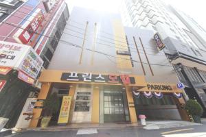 a building on the corner of a city street at Prince Motel in Busan