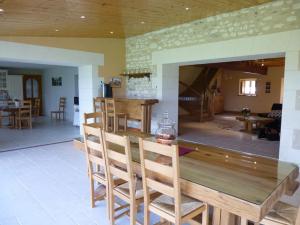 a living room with a wooden table and chairs at La prée in Seligny