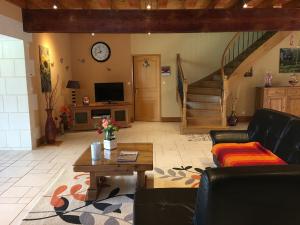 a living room with a couch and a table at La prée in Seligny