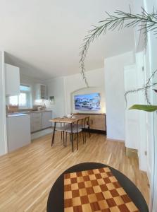 a living room with a table and a kitchen at Romantic Old Town Hideaway in Haapsalu