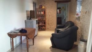 a living room with two chairs and a table at Le gîte de la roche in Antigny +9 photos
