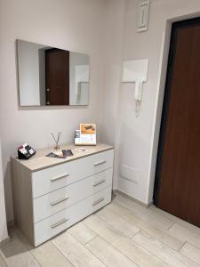 a white dresser in a room with a mirror at Rosy Bed&Breakfast in Terni