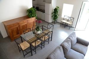 a living room with a couch and a table and chairs at Gîte de la tonnelle in Saint-Georges-lès-Baillargeaux +7 photos