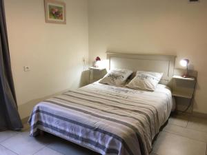 a bedroom with a large bed with two pillows at Le moulin de preuillé in Valence en Poitoux