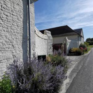 a white building with purple flowers in front of it at L'althéa in Saint-Gervais-les-Trois-Clochers +14 photos