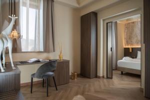 a bedroom with a desk and a giraffe on the wall at Just Hotel Saronno in Saronno +101 photos