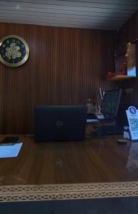 an office with a desk with a laptop and a clock at Hotelthemarwarexcellency in Jodhpur