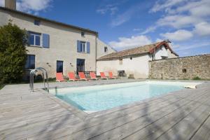 a swimming pool in front of a house at Le clos mélior in Lusignan