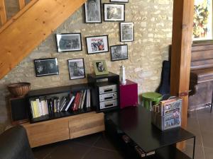 a room with a desk and a shelf with books at Le clos constance in Yversay +3 photos