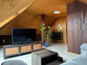 a living room with a large flat screen tv at Hotel Restaurant 7 Berge am Schlehberg in Alfeld