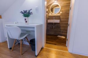 a bathroom with a white desk and a sink at Hotel Boutique Libris in Sarajevo +88 photos