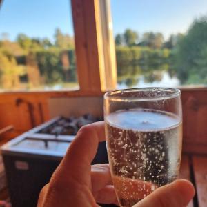 a person is holding a glass of beer at Kaggestorps Gård in Hjo