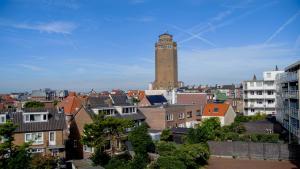 a tall building with a clock tower in a city at Residence Paradis in Zandvoort