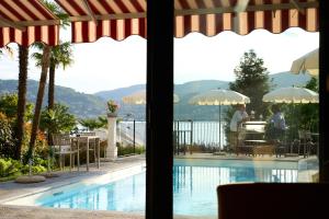 a view of a swimming pool from a resort at Hotel Belvedere Ranco in Ranco