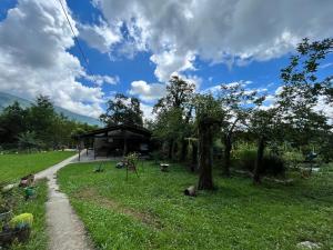 a cabin in a field with trees and a path at Dali`s Guest House in Lebach'e +25 photos