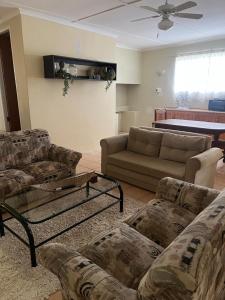 a living room with two couches and a couch at Boschberg Accommodation in Somerset East