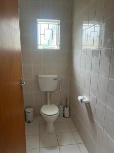 a bathroom with a toilet and a window at Boschberg Accommodation in Somerset East +7 photos