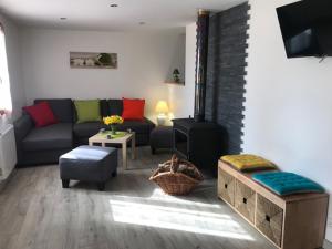 a living room with a couch and a fireplace at Le chalet des forges in Mairé