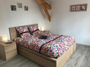 a bedroom with a bed with a laptop on it at Le chalet des forges in Mairé