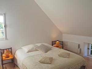 a bedroom with a bed with two pillows on it at Les tilleuls in Persac