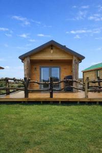 a log cabin with a large wooden deck at Cabin View in Cuminestown