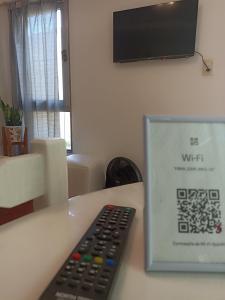 a remote control sitting on a table next to a sign at Lezca in Concordia