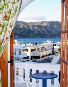 a room with a view of the ocean from a balcony at Sea Stone Apartments in Karpathos
