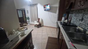 a kitchen with a sink and a counter top at Casa Grilla in Assemini