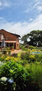 a brick house with a garden in front of it at Udayana House in Hillcrest