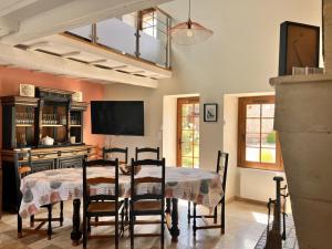 a dining room with a table and chairs at Le chant du jau in Beaumont