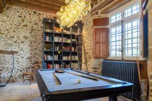 a ping pong table in a room with a book shelf at Le Grand Mesnil - Collection Idylliq in Pré-en-Pail