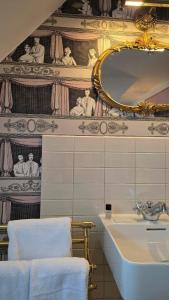 a bathroom with a sink and a mirror at Hôtel du Train in Munich +71 photos