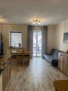 a living room with a couch and a table at Apartament KROPELKA in Piechowice