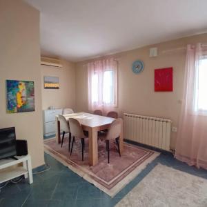 a dining room with a table and chairs at Podgorica apartment in Podgorica