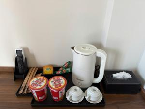 a coffee maker on a tray with cups of coffee at 19 home in Hue +17 photos