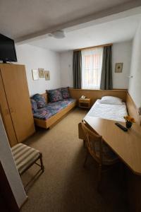 a hotel room with a bed and a table and a desk at Hotel Ritter in Tuttlingen