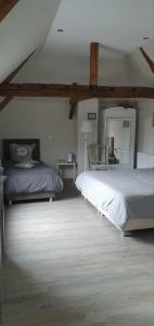 a bedroom with two beds and a mirror at Chambres d'Hôtes des Rouets in Fourmies +39 photos