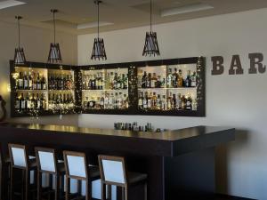 a bar with a bunch of bottles of alcohol at Yeghevnut Hotel in Goris +37 photos