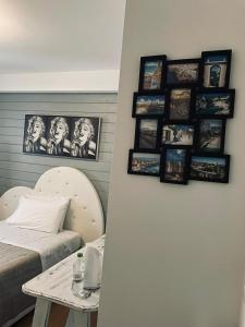 a room with a bed and a table with pictures on the wall at Aleroom25 in Bari
