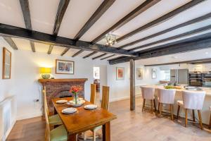 a kitchen and dining room with a table and a fireplace at 6 Bed in Docklow oc-d31042 in Docklow