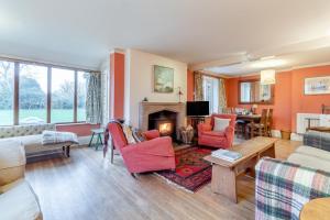 a living room with orange walls and a fireplace at 4 Bed in Walberswick oc-hfarm2 in Walberswick